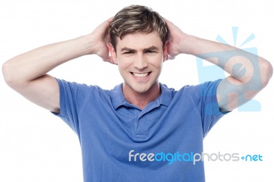 Young Man Holding Hands Behind His Head Stock Photo