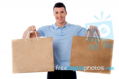 Young Man Holding Shopping Bags Stock Photo