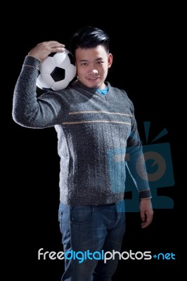 Young Man Holding Soccer Football With Smiling Face Standing Aga… Stock Photo