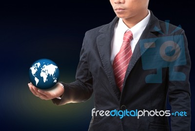 Young Man Holding World Globe In Hand Stock Photo