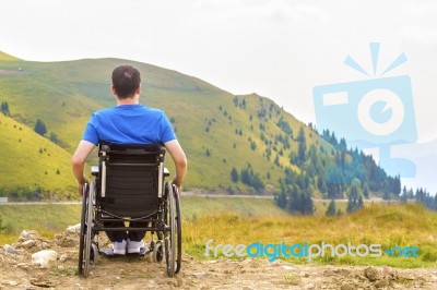 Young Man In A Wheelchair Enjoying Fresh Air On A Sunny Day Stock Photo