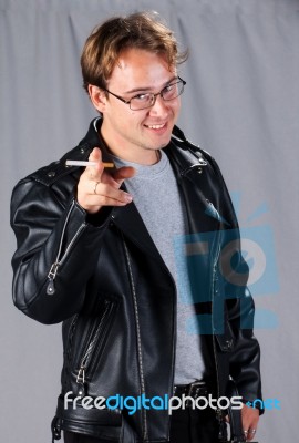 Young Man In Leather Jacket With Cigarette Stock Photo