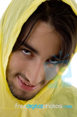 Young Man In Yellow Raincoat Stock Photo