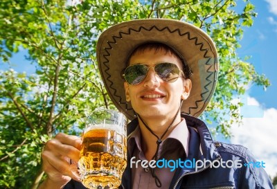 Young Man Is Drinking Beer In The Park Stock Photo