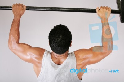 Young Man Lifting Dumbbells Stock Photo