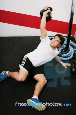 Young Man Lifting Kettlebell Stock Photo