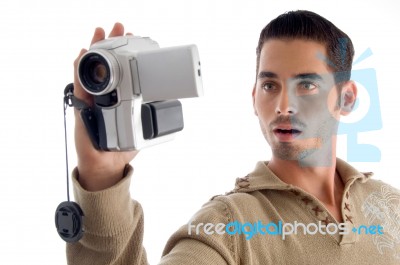 Young Man Looking In To Video From Handy Cam Stock Photo