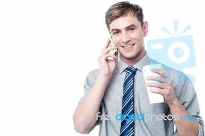 Young Man On Call, Enjoying His Refreshment Stock Photo