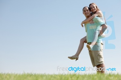 Young Man Piggy Backing Stock Photo