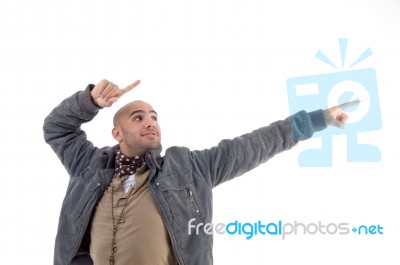 Young Man Pointing Sideways Stock Photo