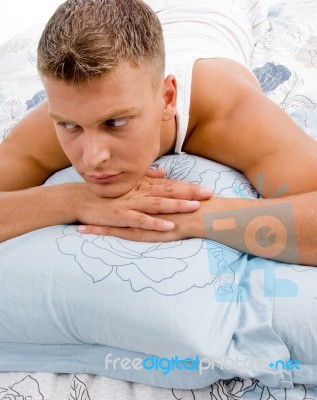 Young Man Relaxing In Bed Stock Photo