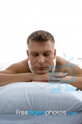 Young Man Relaxing On Bed Stock Photo