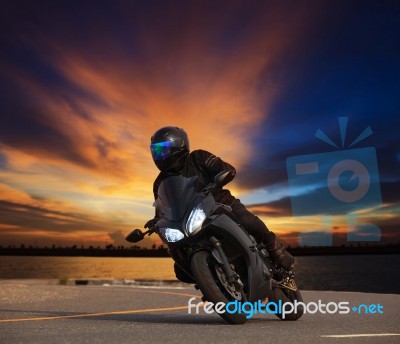 Young Man Riding Big Bike Motorcycle Leaning Curve On Asphalt Hi… Stock Photo