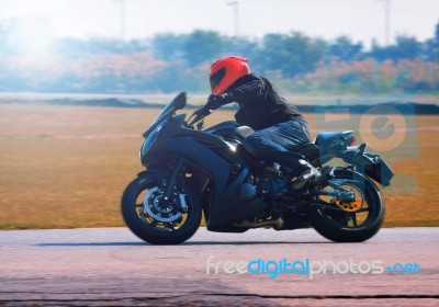 Young Man Riding Motorcycle In Asphalt Road Curve With With A Mo… Stock Photo