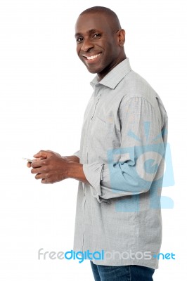 Young Man Sending Message To His Friend Stock Photo