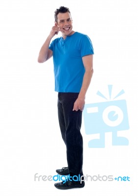 Young Man Showing Call Me Gesture Stock Photo