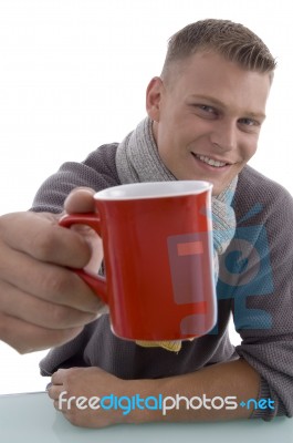 Young Man Showing Coffee Mug Stock Photo