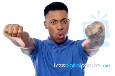 Young Man Showing Thumbs Doown Stock Photo