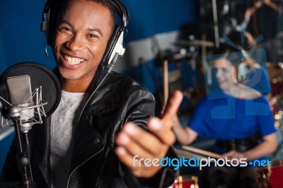 Young Man Singing In Studio Stock Photo