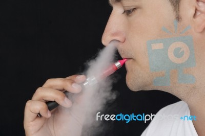 Young Man Smoking An Electronic Cigarette Stock Photo