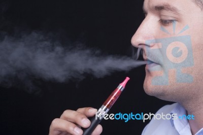 Young Man Smoking E-cigarette Stock Photo