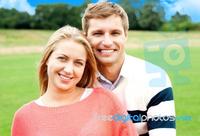 Young Man Standing Behind His Wife Stock Photo