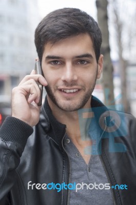 Young Man Talking With Cell Phone Stock Photo