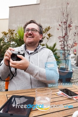 Young Man Traveler Shooting A Vintage Camera Stock Photo