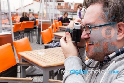 Young Man Traveler Shooting A Vintage Camera Stock Photo