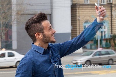 Young Man Using A Smart Phone Stock Photo