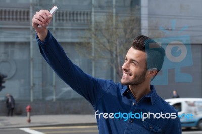 Young Man Using A Smart Phone Stock Photo