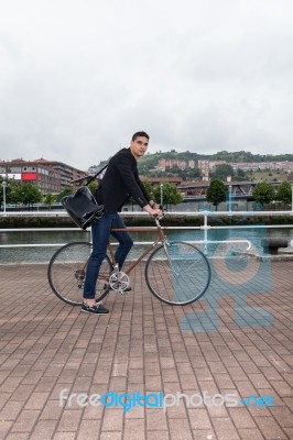 Young Man Walking With An Urban Bike Stock Photo