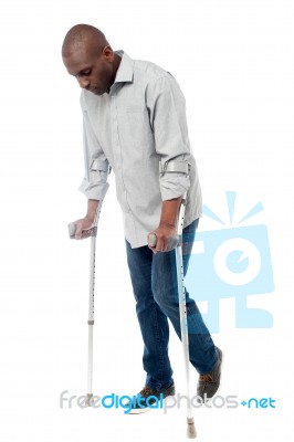 Young Man With Crutches Trying To Walk Stock Photo