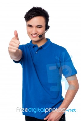 Young Man With Earphones And Thumb Up Stock Photo