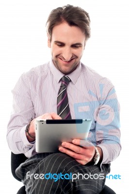 Young Man Working On Tablet Device Stock Photo