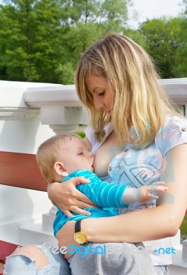 Young Mother Breastfeeding Her Son Stock Photo