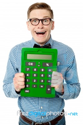 Young Nerd Showing Big Green Calculator Stock Photo