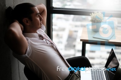 Young Office Worker Is Relaxing Stock Photo