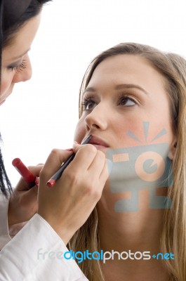 Young Pretty Beautician Applying Lipstick Stock Photo