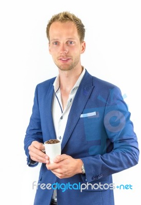 Young Salesman Promoting Coffee Beans In Cup Stock Photo