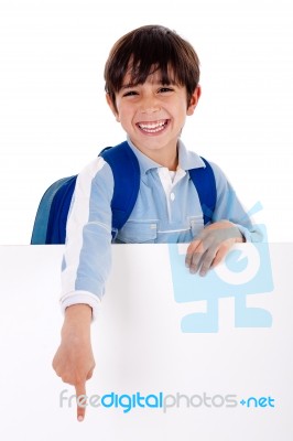 Young School Boy Showing His Fingers Down From Behind The Board Stock Photo