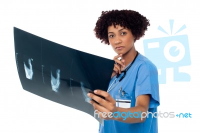 Young Serious Lady Surgeon Holding X-ray Sheet Stock Photo