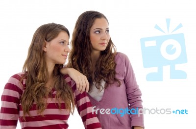 Young Sisters Looking Sideways Stock Photo