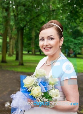 Young Smiling Bride With A Bouquet Of Roses Stock Photo