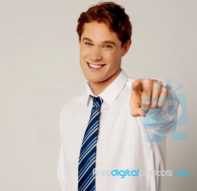 Young Smiling Businessman Pointing You Out Stock Photo