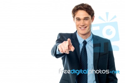 Young Smiling Businessman Pointing You Out Stock Photo