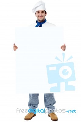 Young Smiling Chef Holding Billboard Stock Photo