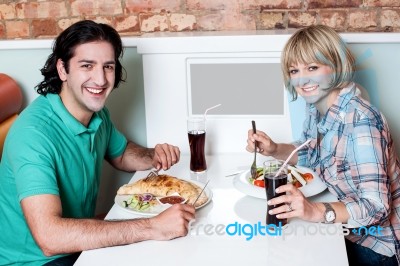 Young Smiling Couple Enjoying Lunch Stock Photo