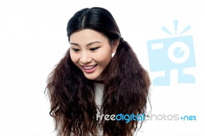 Young Smiling Girl Looking Down Stock Photo