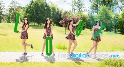 Young Smiling Girls Holding Letters With The Word Love Stock Photo